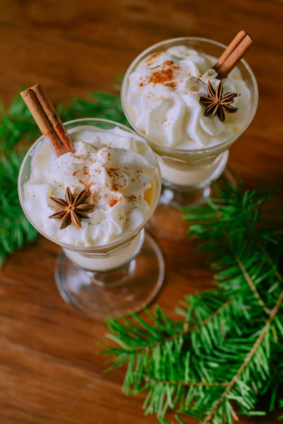 italian alcoholic drinks topped with whipped cream cinnamon and star anise