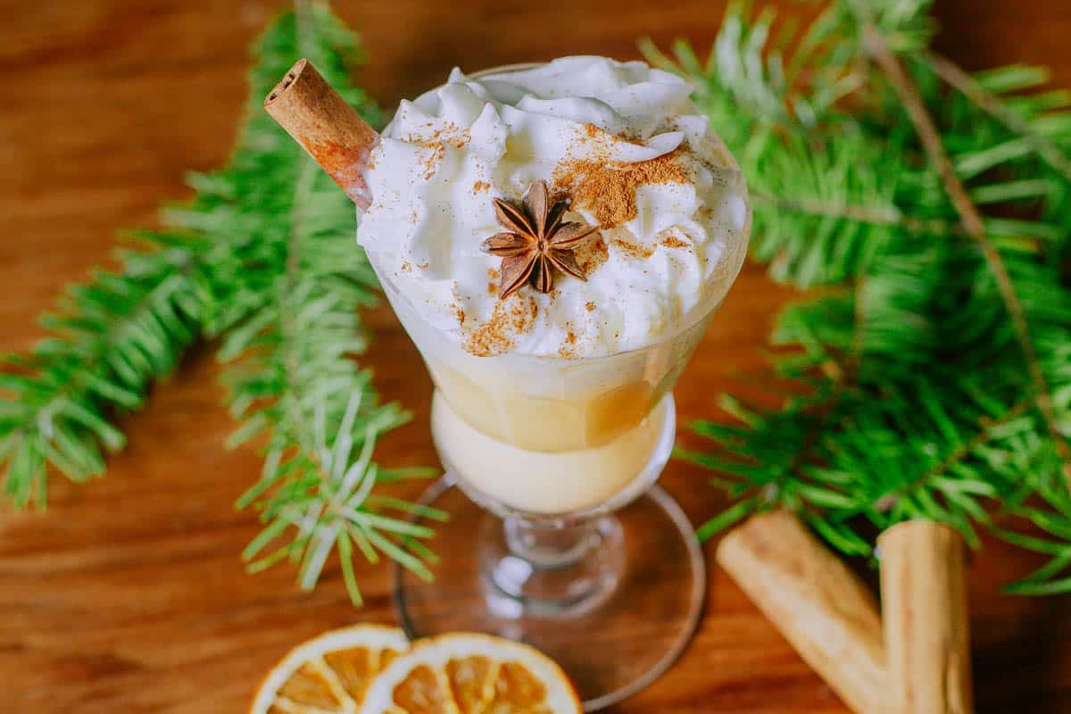 bombardino topped with whipped cream cinnamon and star anise