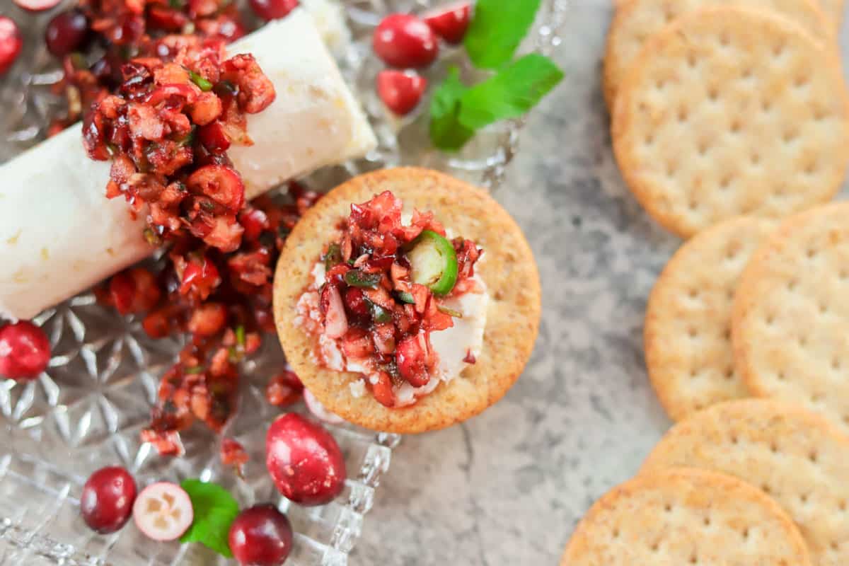 Cranberry jalapeno dip on a cracker with goat cheese