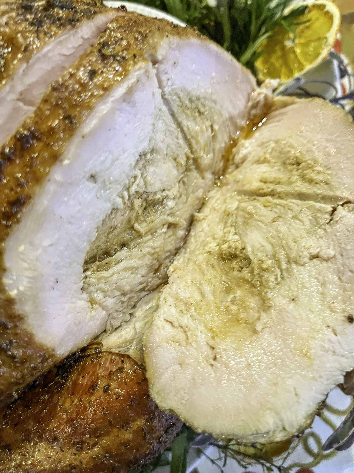 smoked treager turkey breast sliced, showing the juicy center