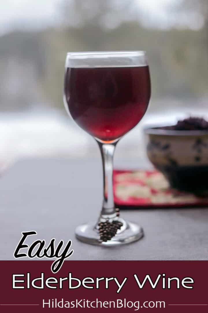 elderberry wine with more elderberries in the background