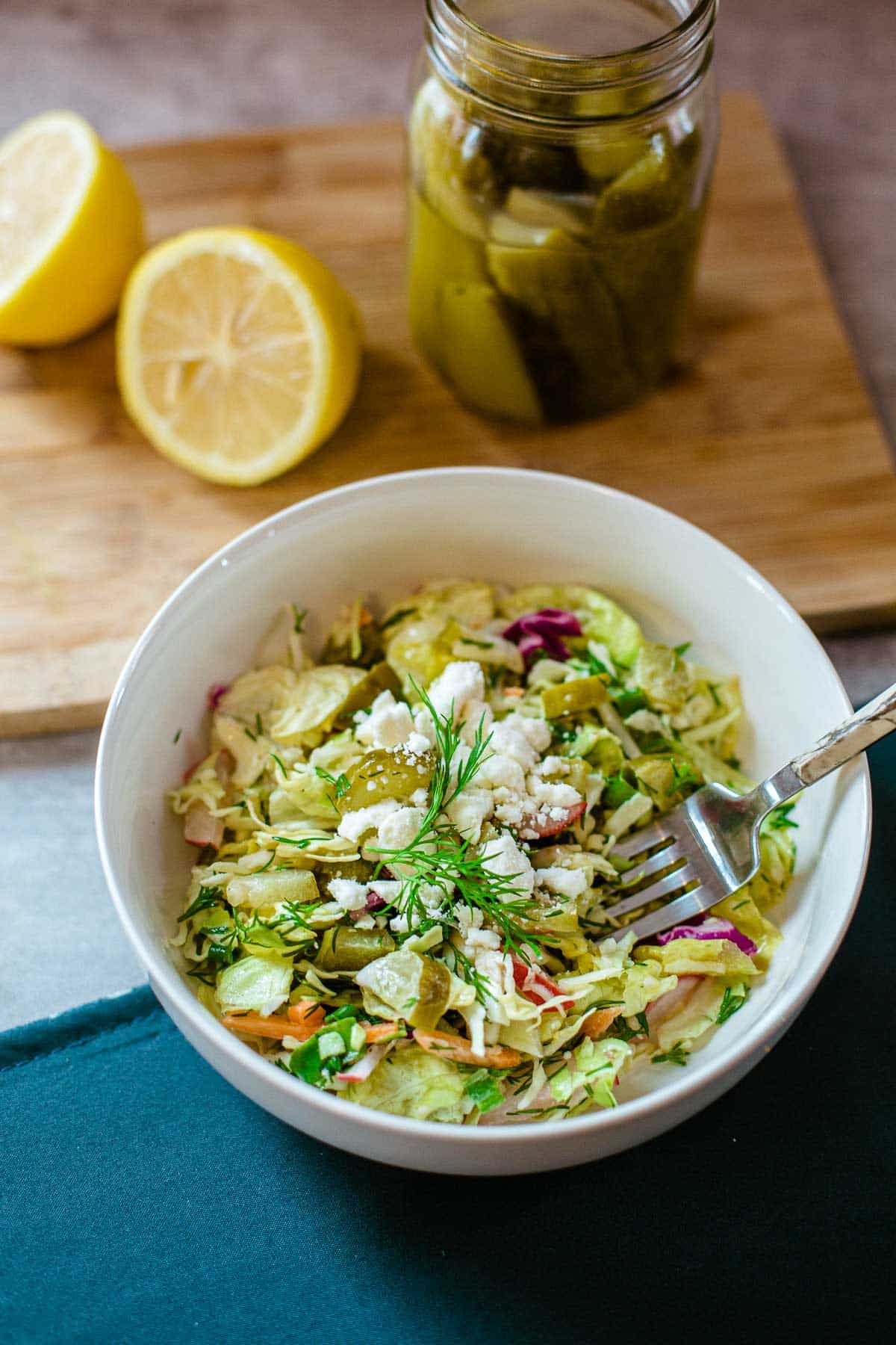 dill pickle chopped salad in bowl with lemon