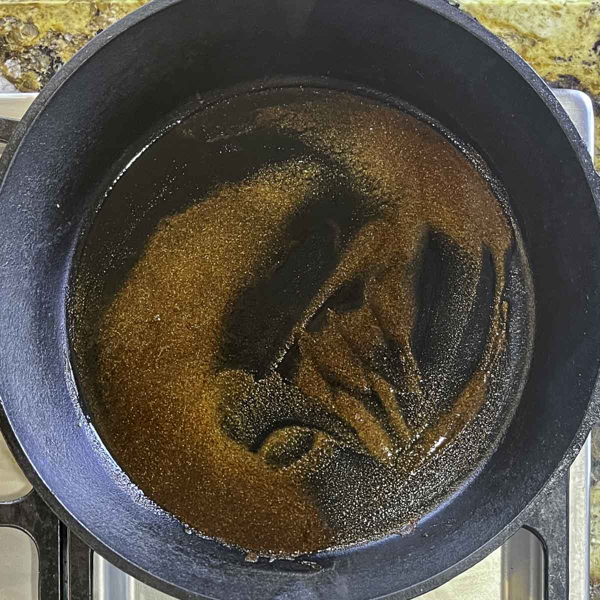 oil and spices in a cast iron skillet