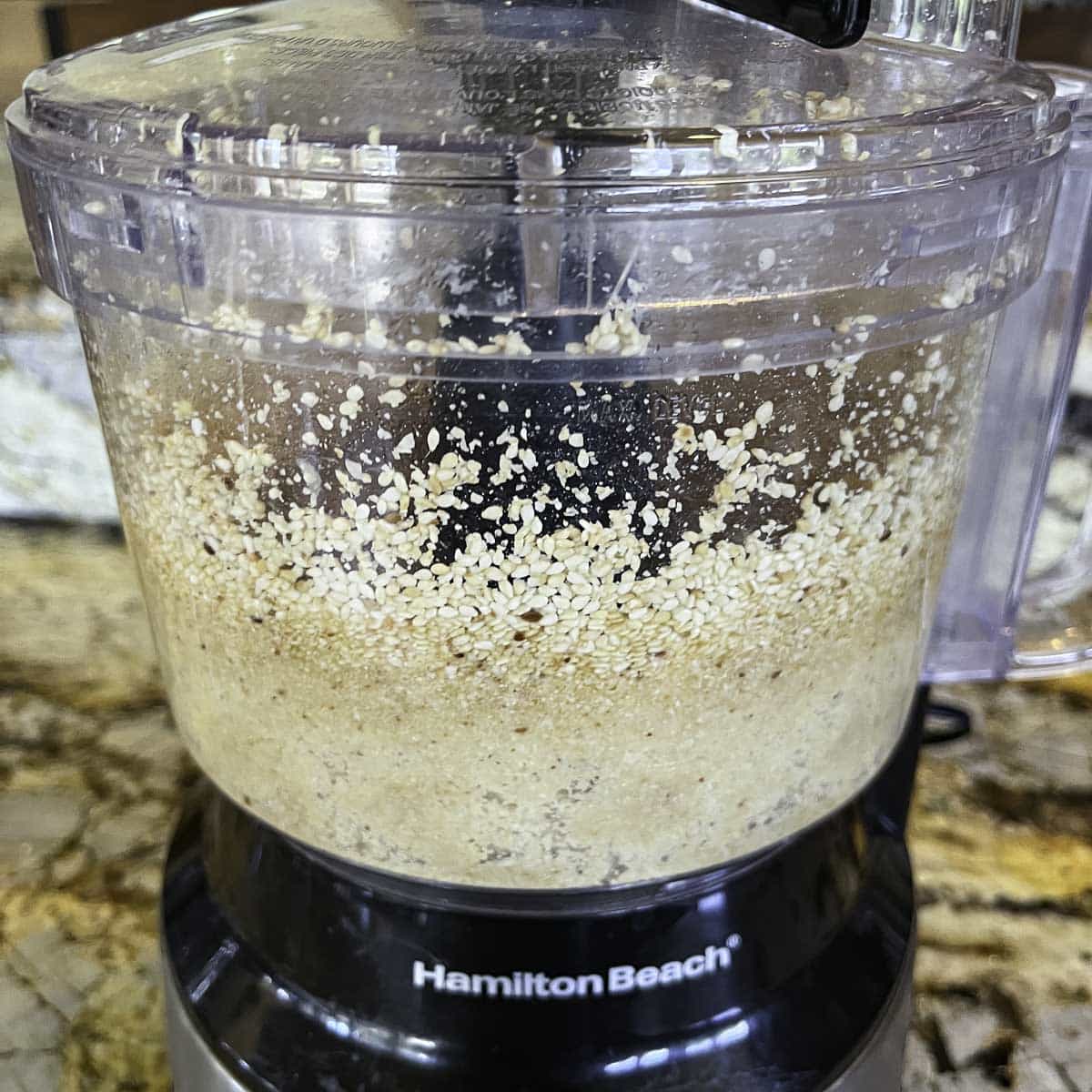 sesame seeds being ground in a food processor