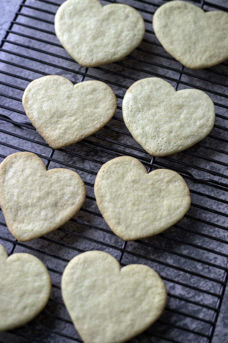 heart shaped sugar cookies on a cooling rack