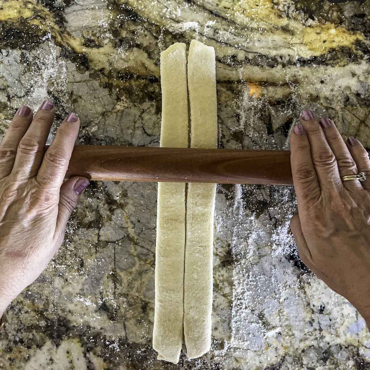 folded pastry dough being rolled 