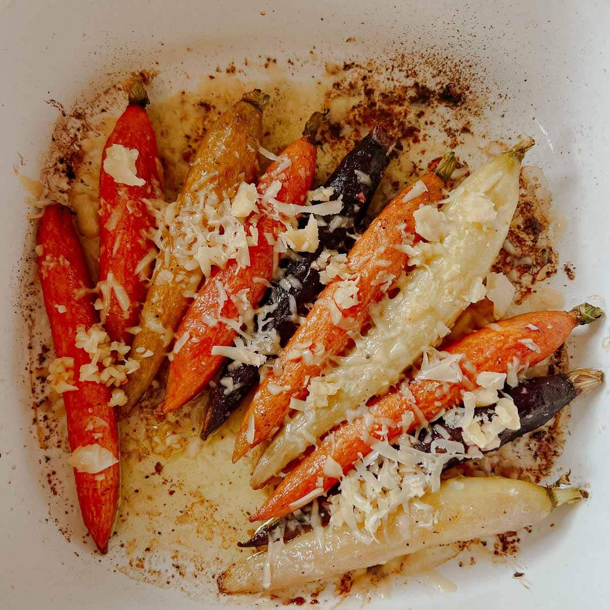 colored carrots in with parmesan and garlic