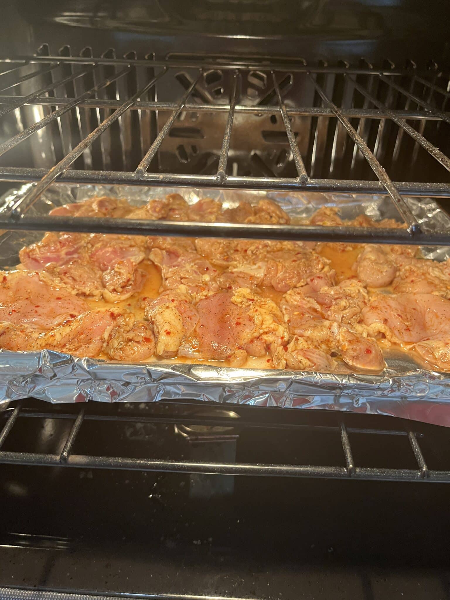 raw chicken baking in the oven