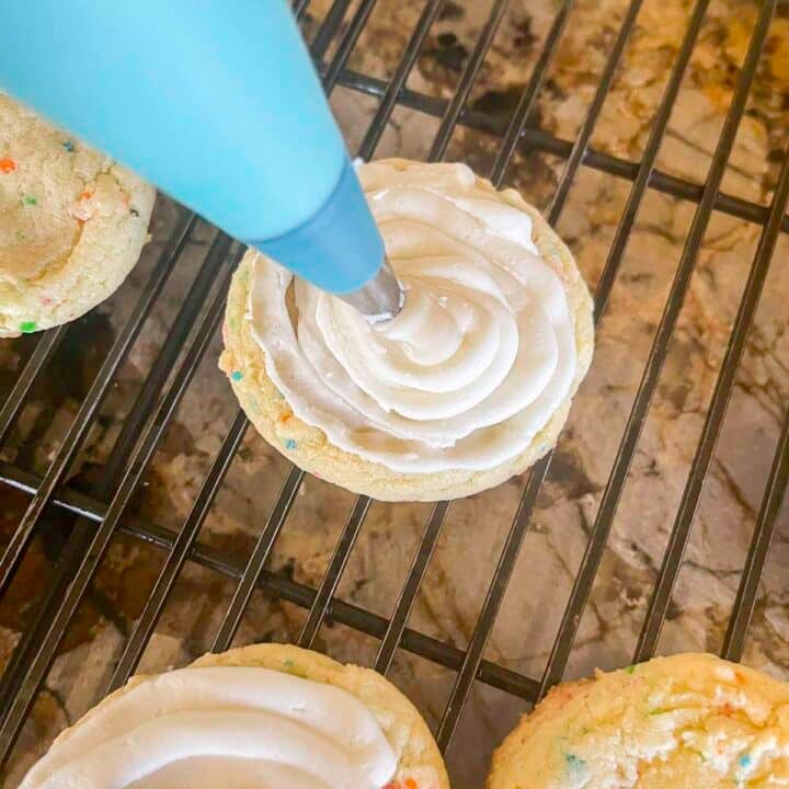piping frosting onto easter egg cookies