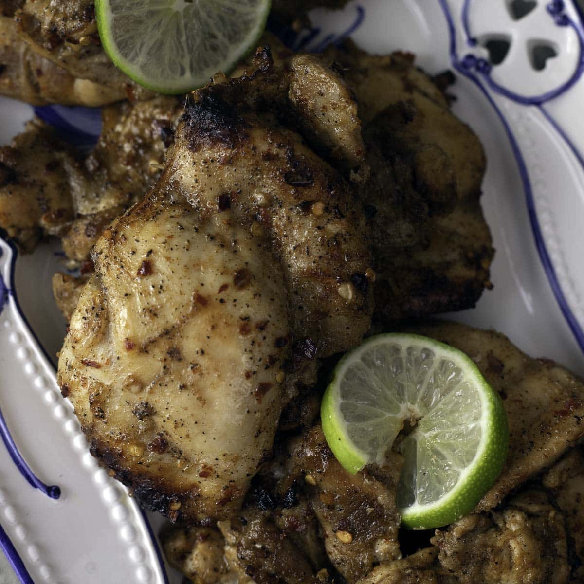 Grilled boneless chicken thighs topped with sliced lime