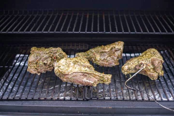4 raw lamb shanks on the grill