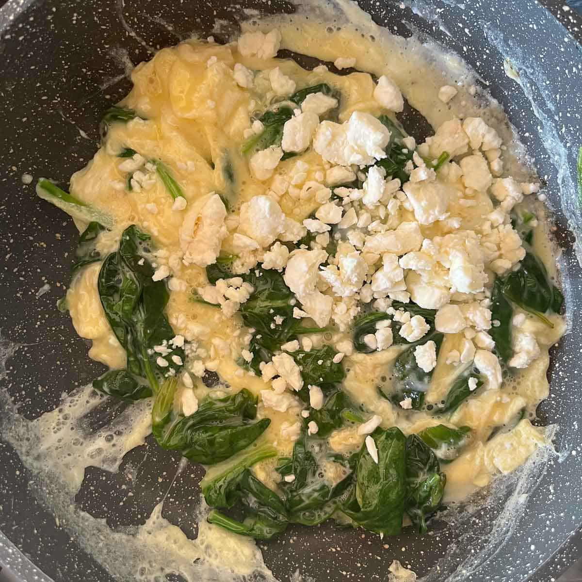 eggs, spinach, and feta in a pan