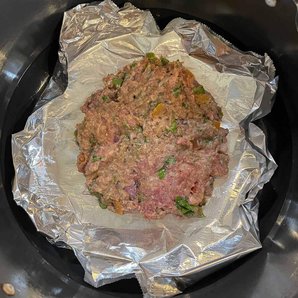 meat Patty on foil in air fryer