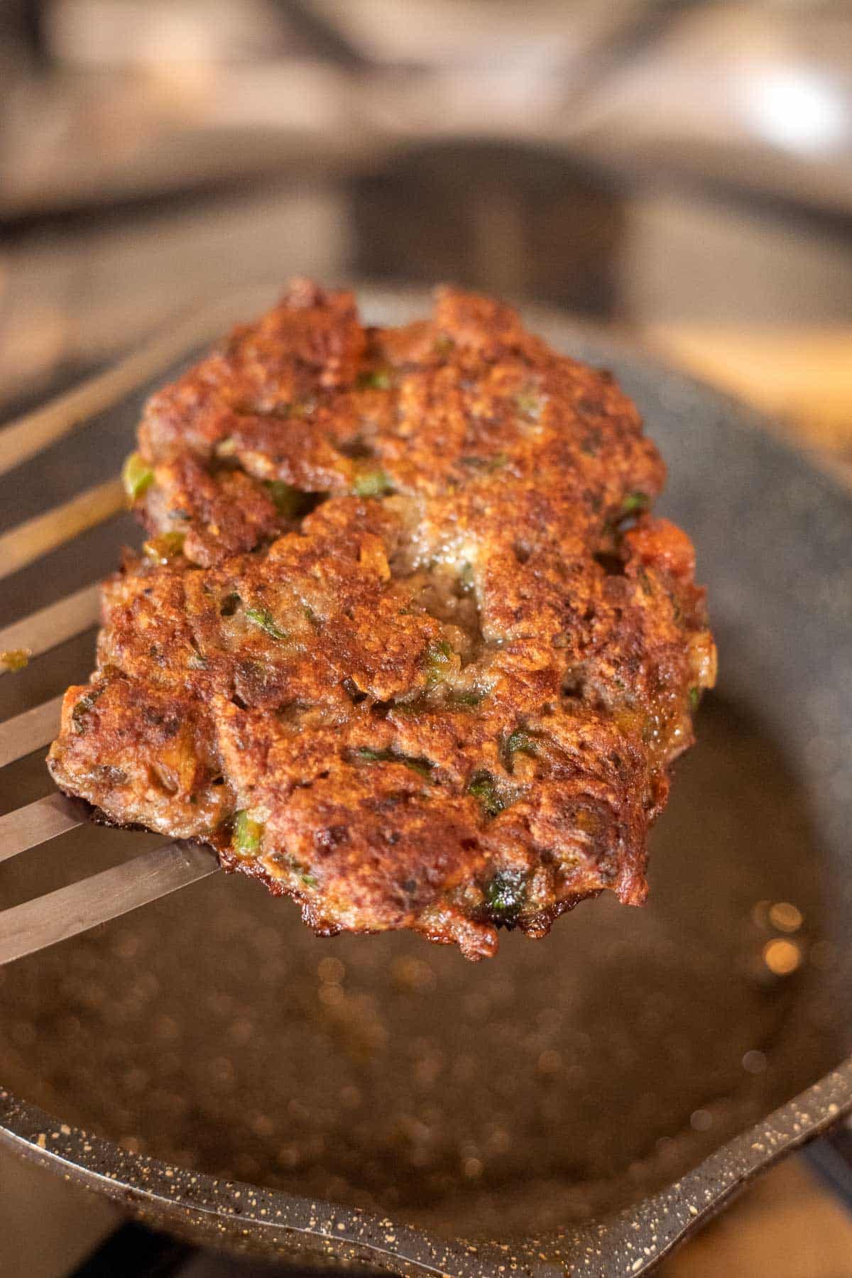 meat patty on a spatula