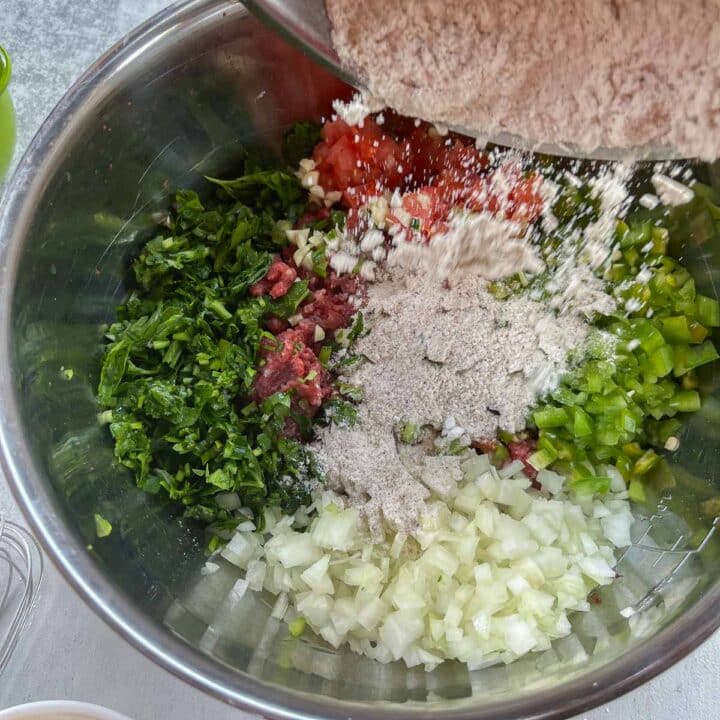 adding flour mixture to meat and veggies in a bowl