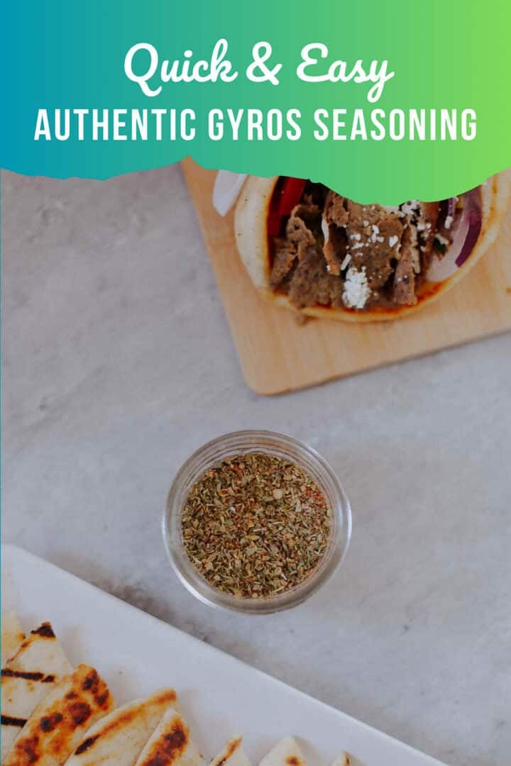gyros seasoning in a jar with gyros sandwich and pita slices