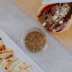 spices in a jar with gyro and sliced pita bread