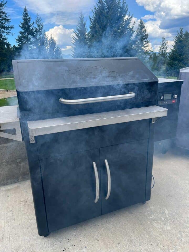 smoker with smoke around it and trees behind it