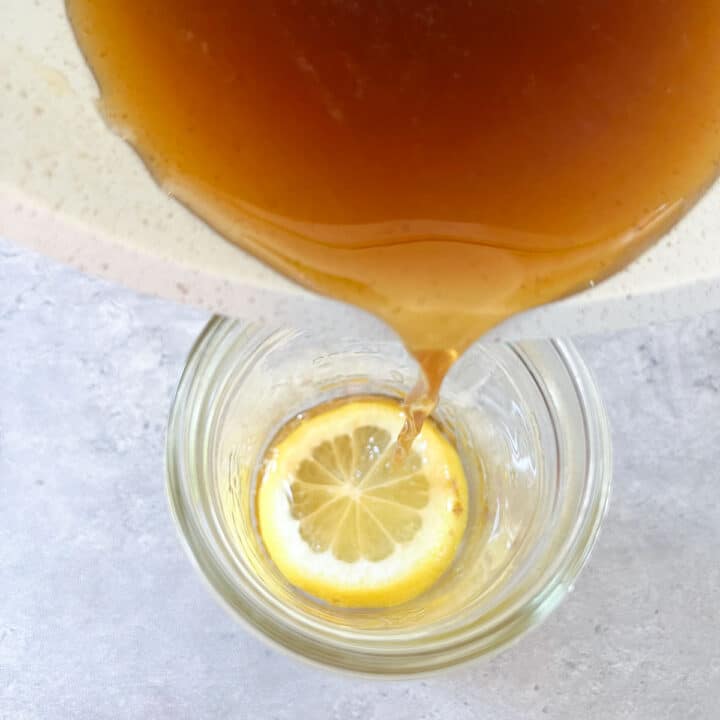 honey syrup being poured over lemon