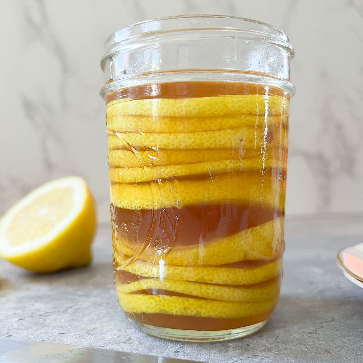 honey syrup and lemon slices in mason jar