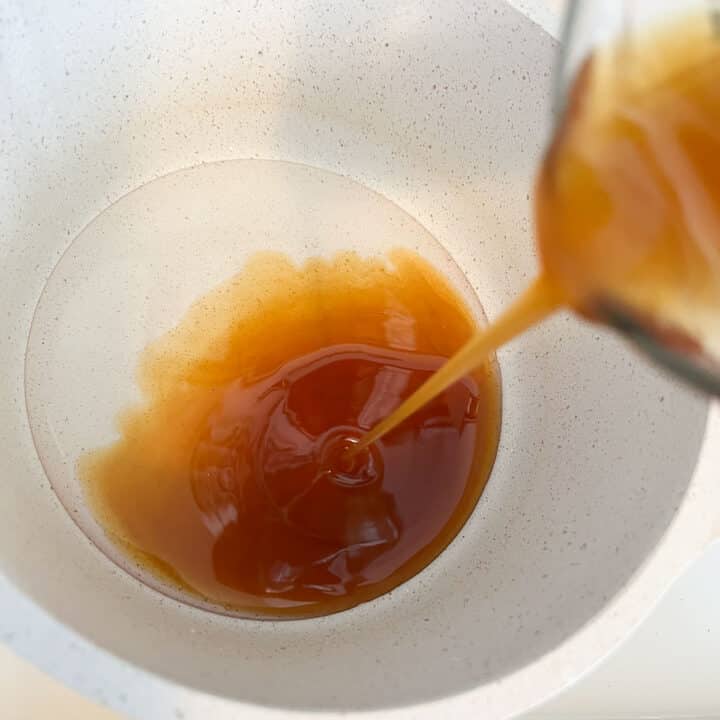 honey being poured into pot