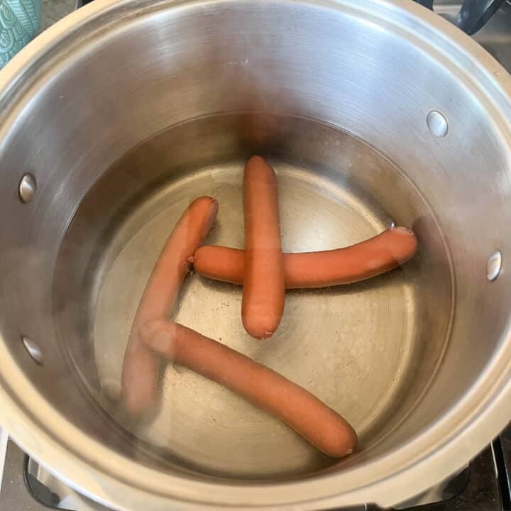 4 hot dogs in a pot of water