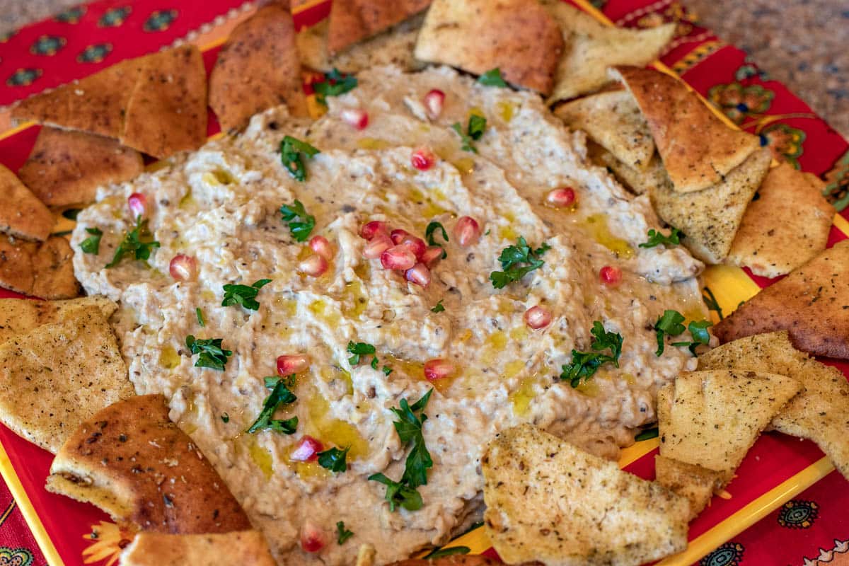 a plate of eggplant dip (mutabal) with pita chips