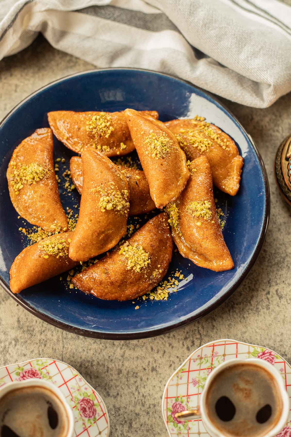 Atayef on a blue plate with Turkish coffee