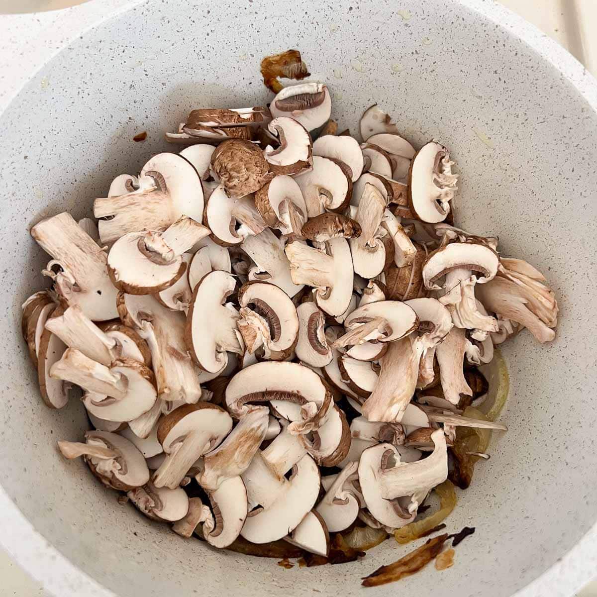 mushrooms added to pot with caramlized onions