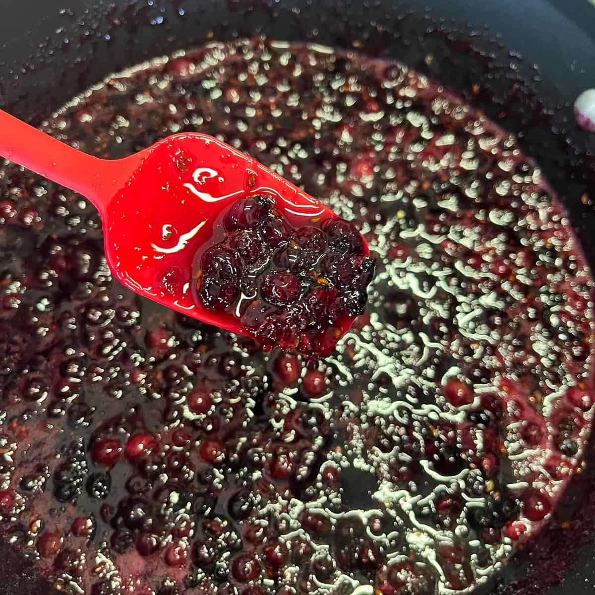 stirring saskatoon berry jam