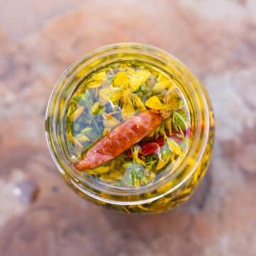 mason jar with st johns wort and cayenne peppers in oil