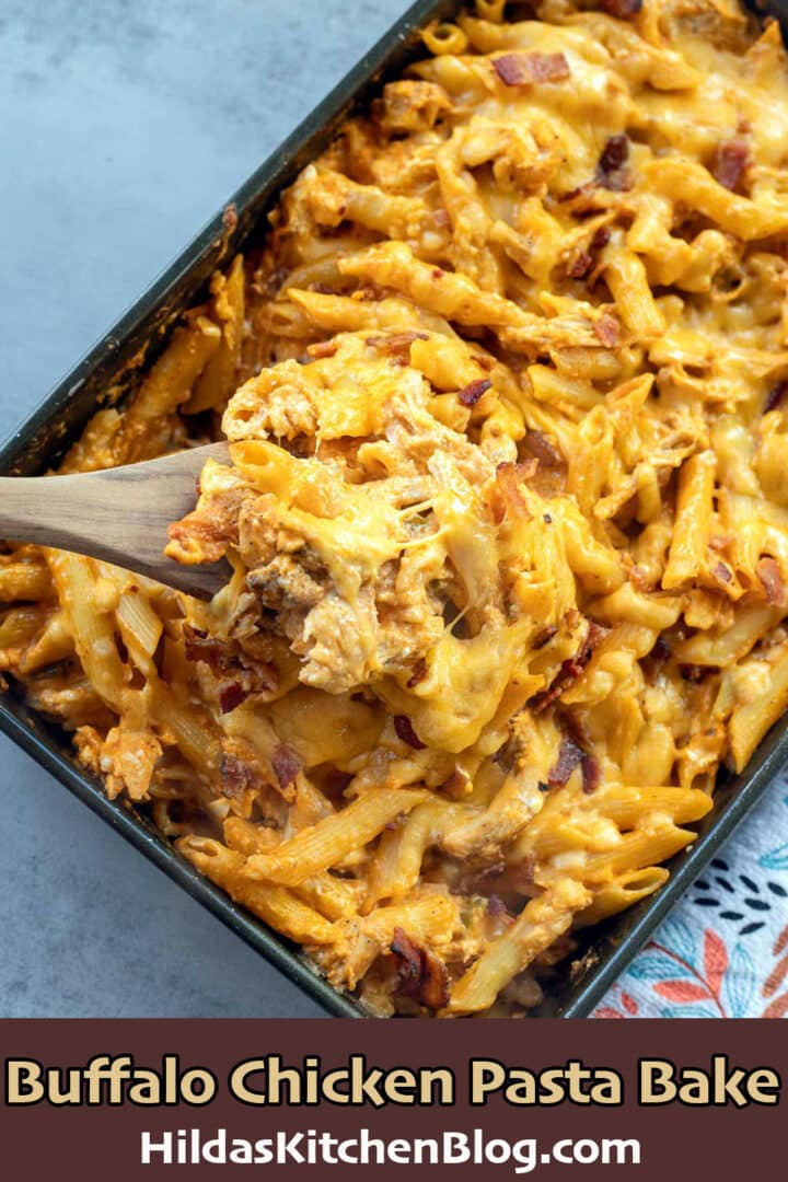 buffalo chicken pasta bake being spooned out of pan