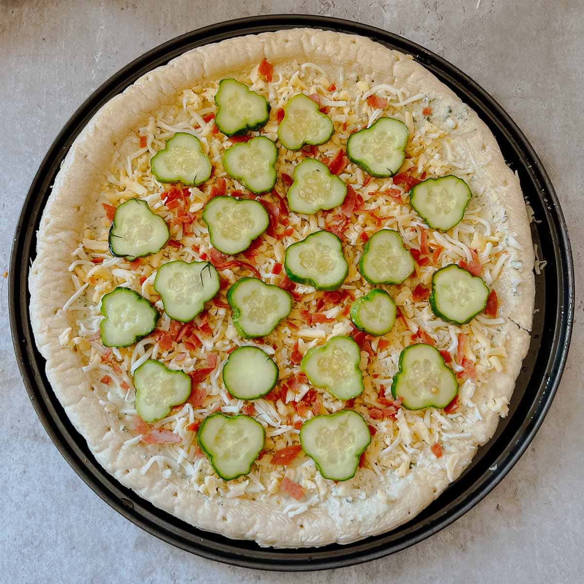 pizza with all toppings before going into oven