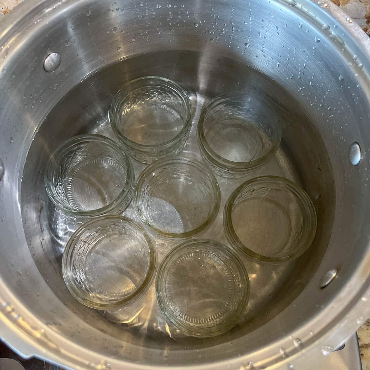 canning jars in a pot of water