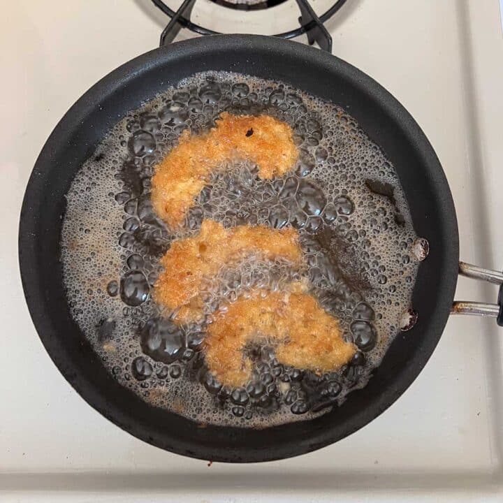 other side of shrimp being fried in pan