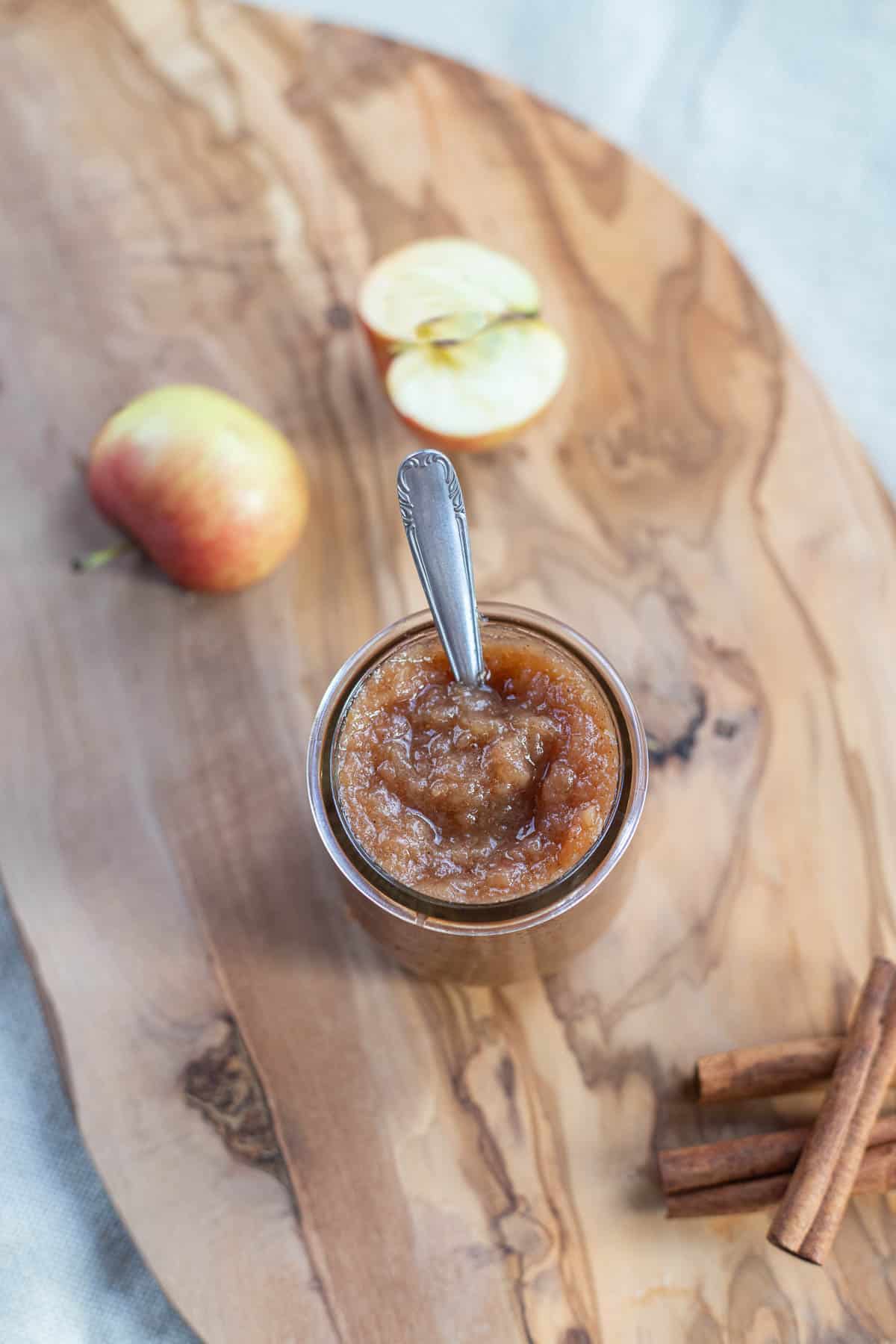 applesauce in a jar with a sliced apple