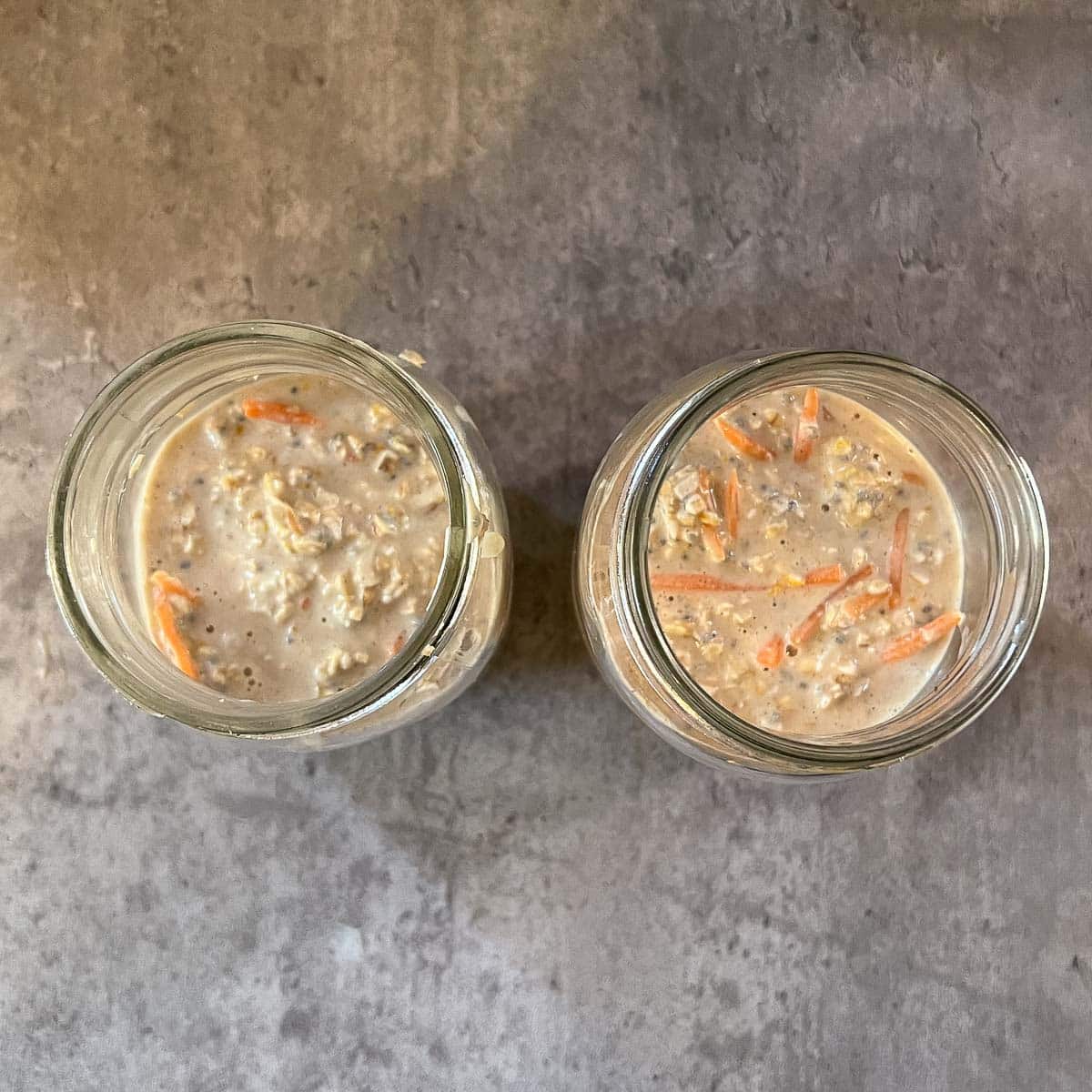 two mason jars with carrot cake overnight oats