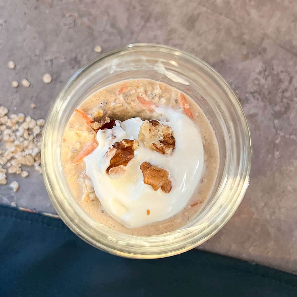 mason jar with overnight oats topped with yogurt and nuts