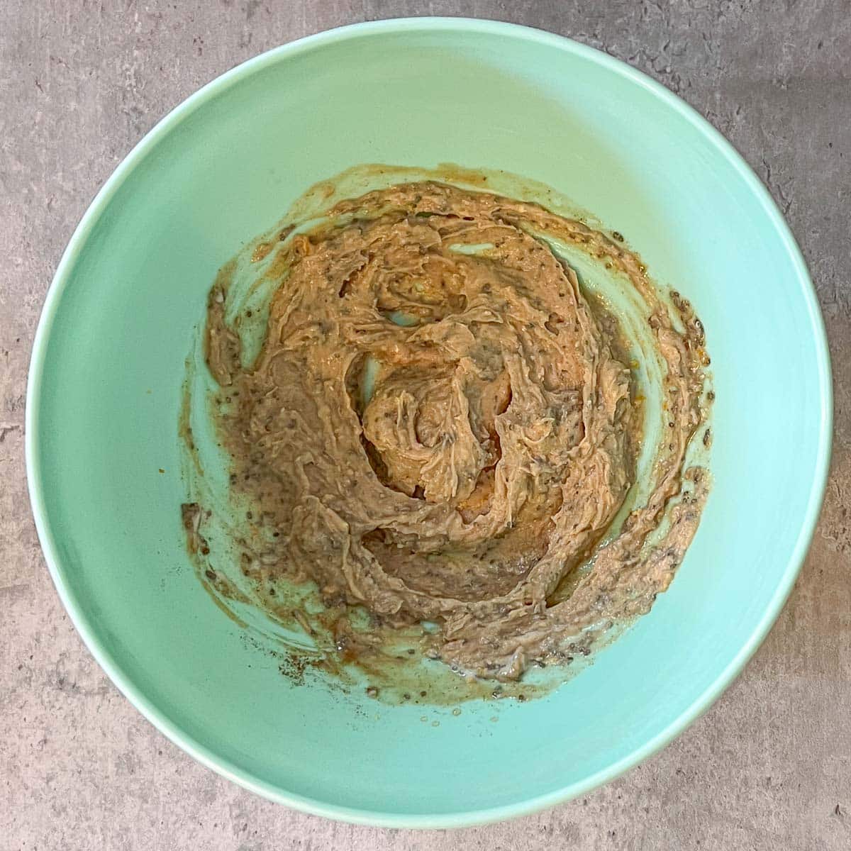 chia seeds, oramge zest, vanilla, maple syrup, spices, cashew butter mixed together in bowl