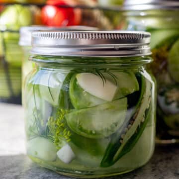 a jar of pickled green tomatoes