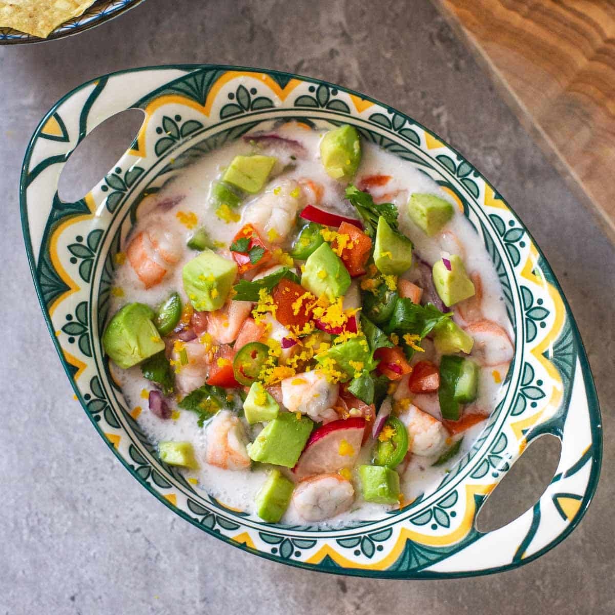 prawn ceviche in dish topped with orange zest
