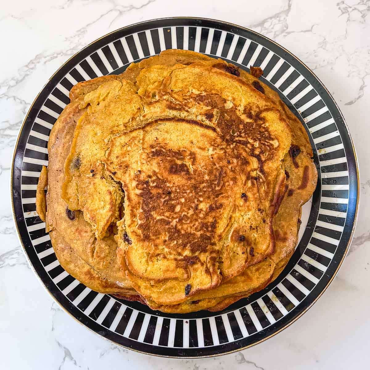 pumpkin spice pancakes stacked on plate
