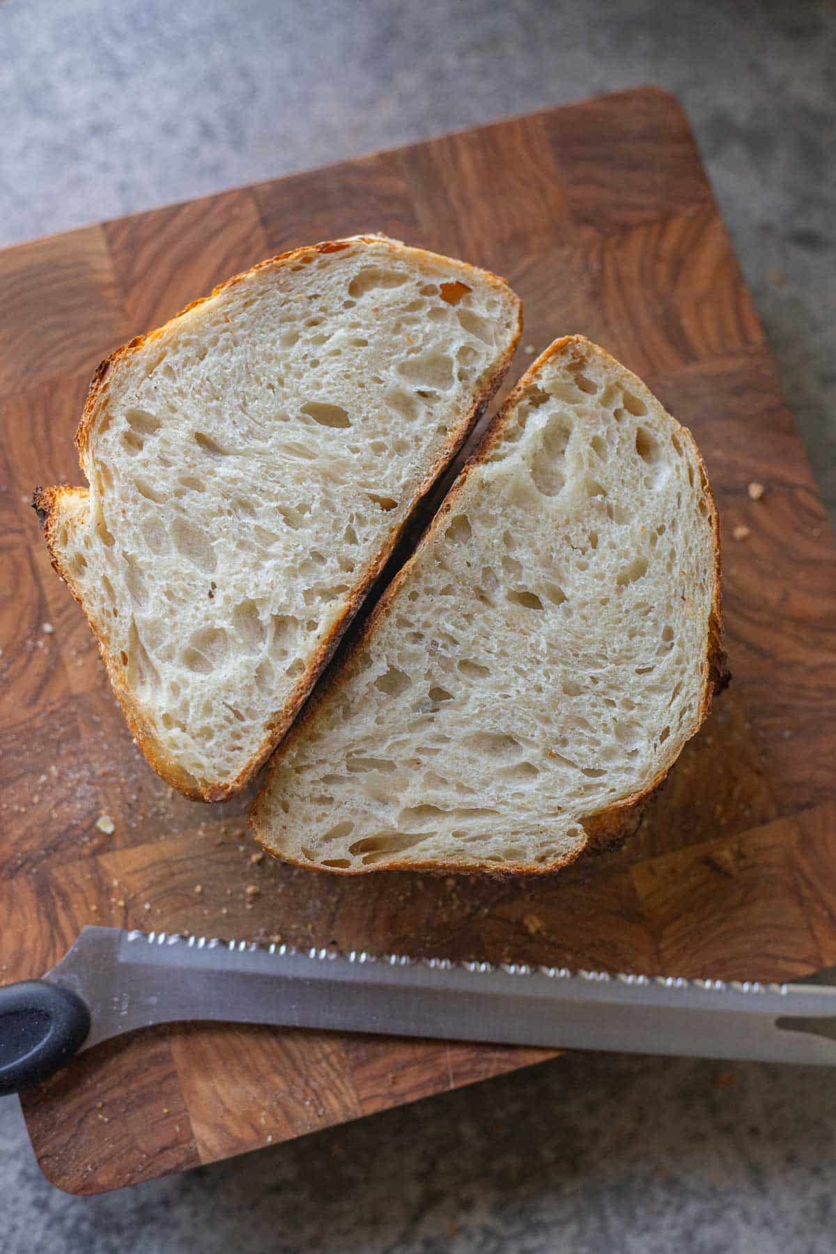 sourdough bread sliced in half on a cutting board