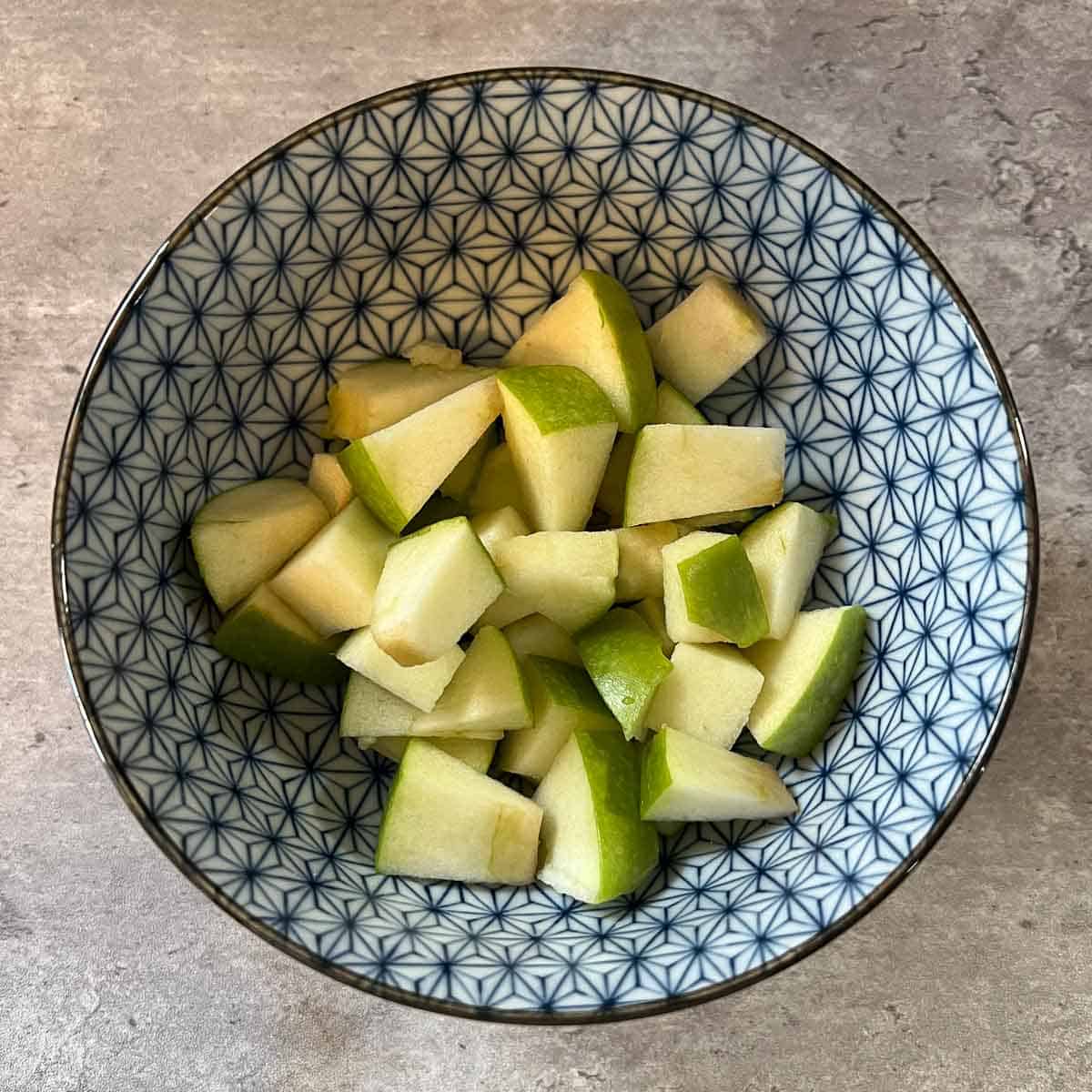 diced green apples in small blue bowl