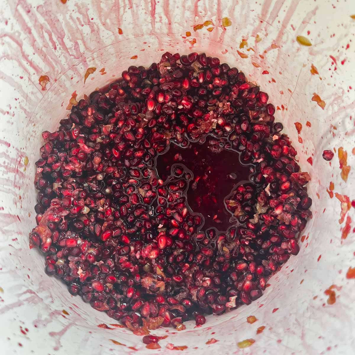 pomegranate seeds in a white bucket for wine