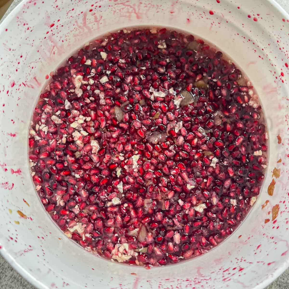 pomegranate seeds being fermented for wine