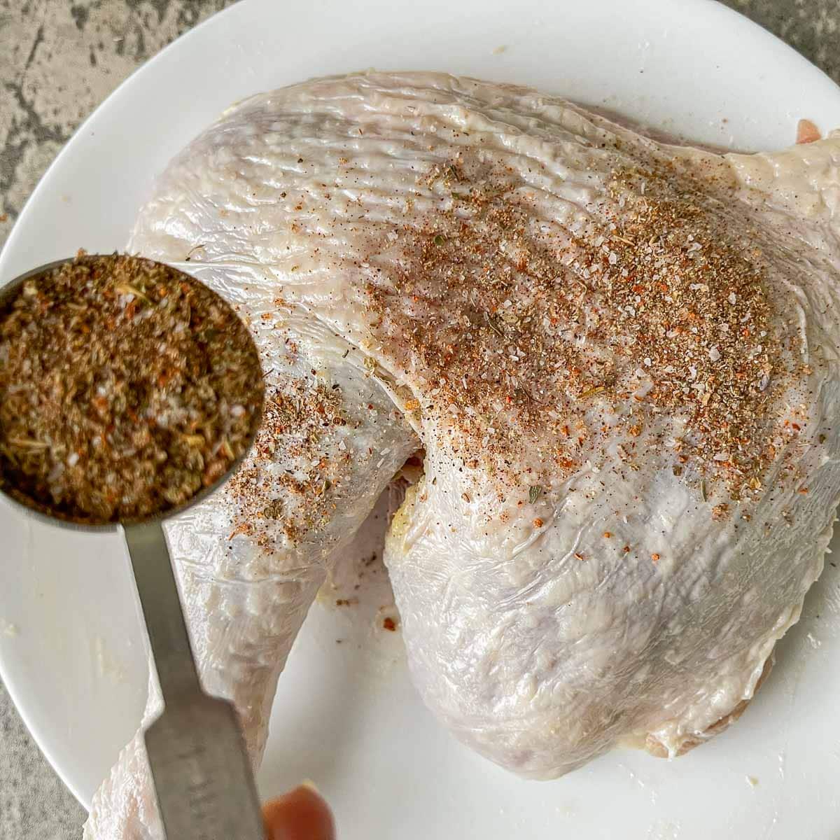 sprinklinf turkey leg with turkey rub