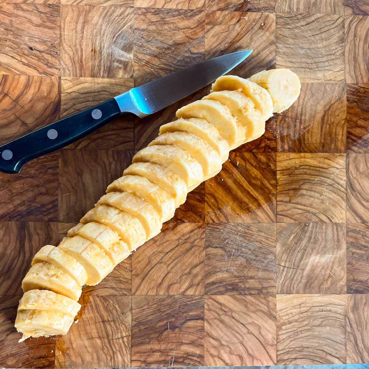 sliced plantain on cutting board beside knife