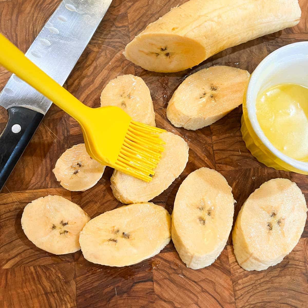brushing ghee on plantains after slicing