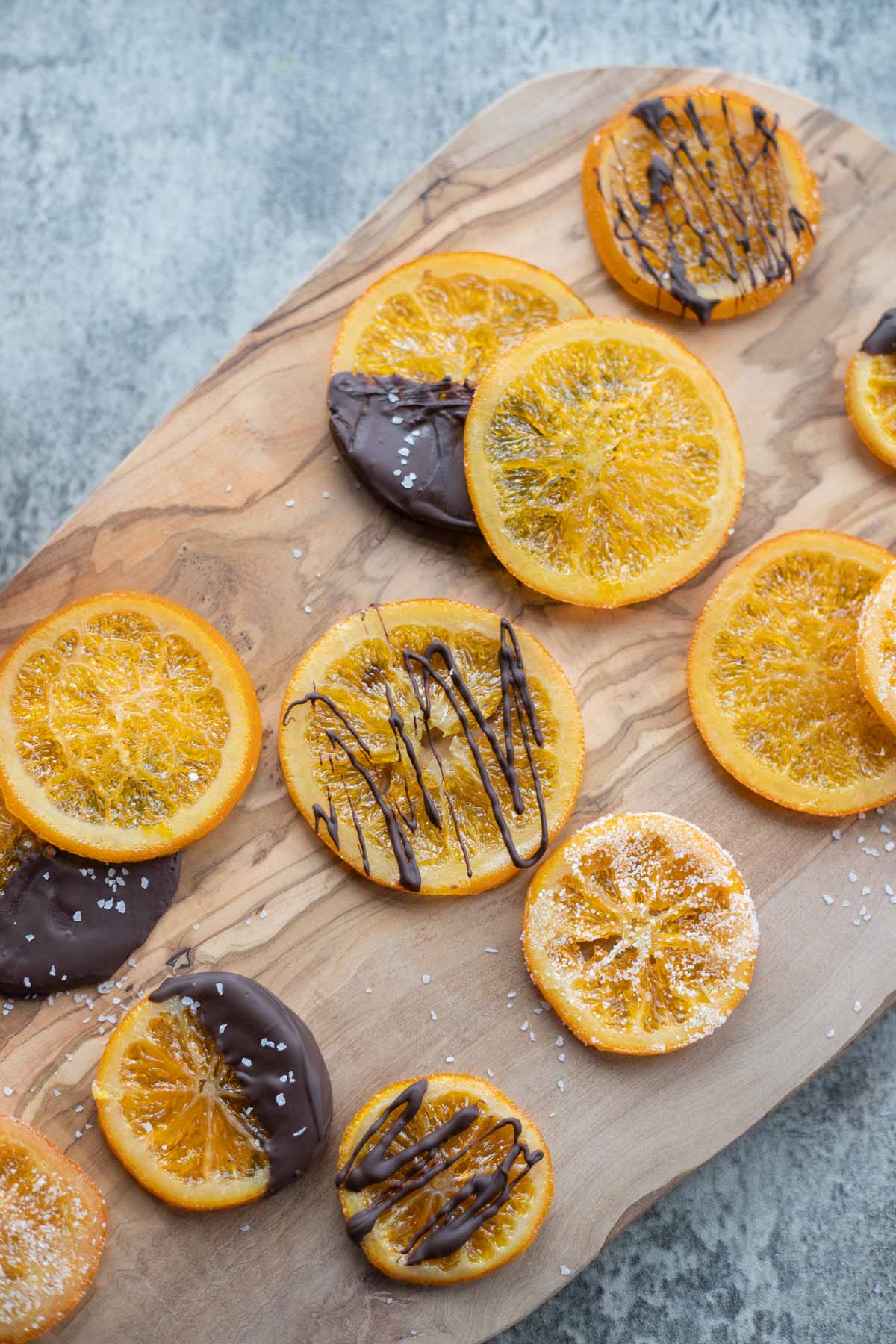 candied orange slices on a wooden board